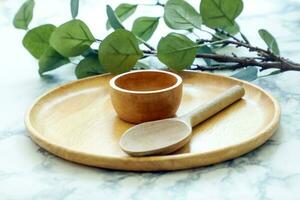 Decorative setting wooden fork spoon pot pizza tray on marble table photo