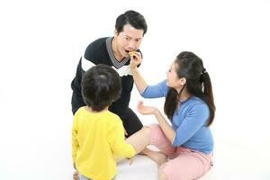 South East Asian young father mother daughter son parent boy girl child activity indoor photo