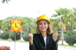 South east Asian construction worker engineer management at construction site hard safety hat helmet photo