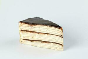 Chocolate crepe layer cake slice white background photo