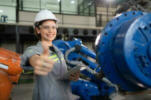 A female engineer completed the updating software and calibrating a robotics arm, Ready to deliver to the next customer. photo