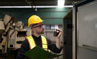 The engineer inspects the electrical system and repairs the mechanical system in the machine control cabinet. in order for the machine to return to normal operation photo