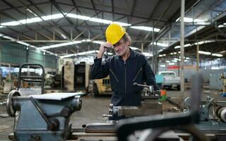 Senior engineer with fatigue from long and hard work photo