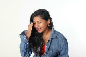 Young attractive Asian Indian woman pose face body expression mode emotion on white background laugh hand on face photo