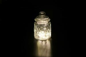 Shining light through glass jar photo