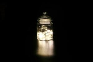 Shining light through glass jar photo