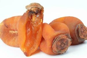 dried permission fruit on white background photo