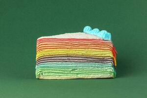 Rainbow crepe layer cake  green background photo