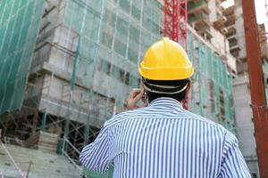 South East Asian young Malay Chinese man woman wearing safely helmet construction site work photo