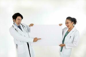 Asian Chinese Malay male female doctor holding posing showing pointing happy exited blank expression happy exited white paper board on white background photo