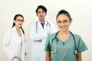 joven asiático malayo chino masculino hembra médico en blanco antecedentes sonrisa confidente mirando a cámara foto