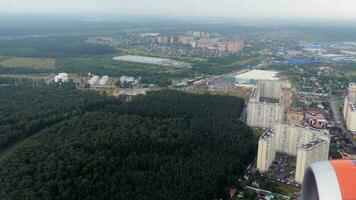 Landing descent over a large modern city, view from the airplane window video