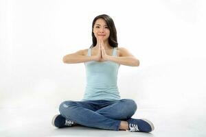 Beautiful young south east Asian Chinese woman yoga workout exercise on white background photo