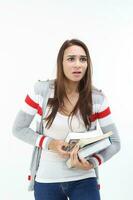 Yong Asian youth girl in casual dress carrying heavy book look at camera funny face expression difficult on white background photo