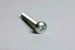 Metal screw plug on white background photo