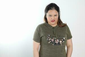 young plus size south east asian woman pose face expression emotion on white background bad disgusting photo