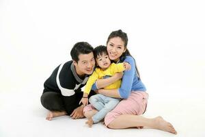 South East Asian Chinese couple husband wife son child play sit on floor look at camera white background love photo