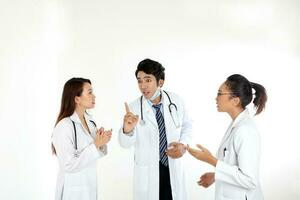 Asian Malay Chinese male female three doctors talking discussing serious pointing finger on white background photo