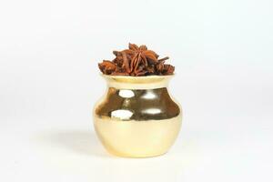 Star anise spice in shiny metal pot photo