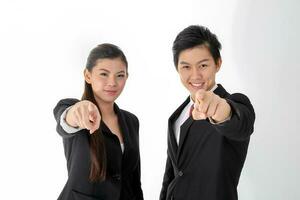 South east Asian young Chinese man woman wearing formal business office ware on white background point at camera photo