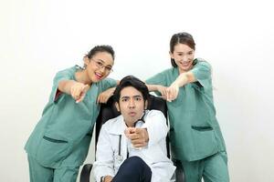 Young asian malay chinese male female doctor sit on chair stand point at camera photo