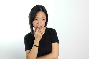 Young attractive south east asian woman pose face expression emotion on white background think finger in mouth photo