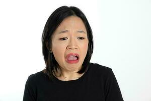 Young attractive south east asian woman pose face expression emotion on white background think worry sad upset scared photo