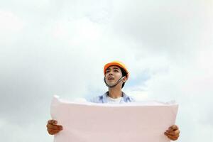 South east Asian construction worker engineer management at construction site hard safety hat helmet photo