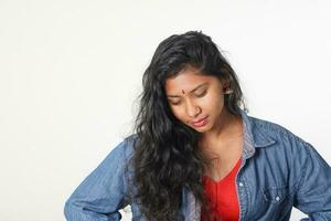 Young attractive Asian Indian woman pose face body expression mode emotion on white background think look down photo