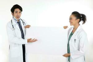 Asian Chinese Malay male female doctor holding posing showing pointing blank expression happy exited white paper board on white background photo