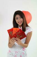 South East Asian young Malay Chinese Indian man woman wearing traditional chinse cheongsam dress on white background shop exchange gift orange greetings share racial unity harmony hand fan photo