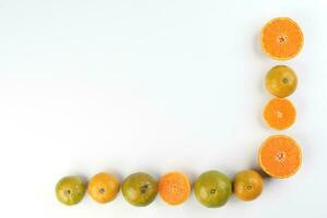 small yellow green mandarin orange whole slice on white background copy space for text frame border photo