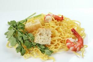Fresh yellow egg noodle prawn tofu coriander leaf on whit background photo