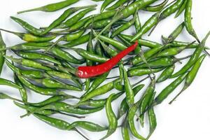 Fresh birds eye green chilli scattered isolated unique red chilli top view on white background photo