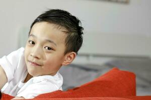 Little boy child looking over the sofa photo