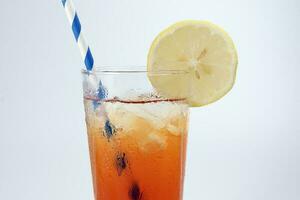 Ice lemon tea with ice cube yellow lemon slice blue white paper straw on white background photo