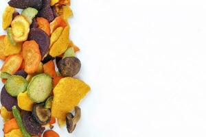 Healthy vegetable chips yellow sweet potato purple sweet potato carrot green radish green beans and shiitake mushrooms photo