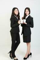Two young asian malaysian business office woman holding blank copy text space sign board on white background photo