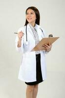 Young Asian female doctor wearing apron stethoscope holding writing on a clipboard photo