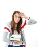 Yong Asian youth girl in casual dress carrying heavy book look at camera funny face expression difficult tired on white background photo