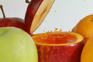 Red Apple real juice splash in fresh half cut hollow cup fruit photo