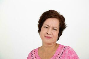 Elderly asian Chinese female on white background look at camera sad upset photo