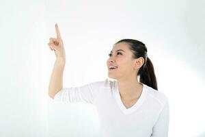 beautiful young south east Asian Chinese woman pointing finger up on white background photo