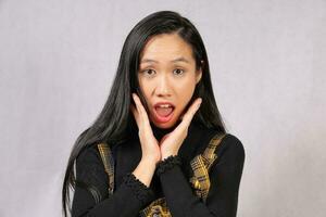 Young attractive southeast Asian woman posing facial expression shocked surprised photo