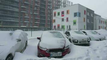 carros cubierto por nieve después un nieve tormenta de nieve. residencial edificio en el antecedentes video