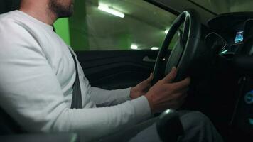 Man driving in innovative automated car using self-parking autopilot for parking on parking lot video