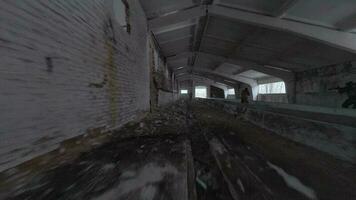 Group of people in masks and military uniforms are engaged in airsoft in an abandoned building. FPV drone shooting video