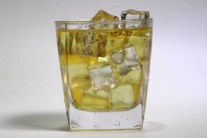 Apple Juice dripping flowing through frosted glass ice cube photo