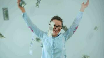 Woman piles as many US dollar bills as possible on the floor video