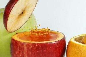 Red Apple real juice splash in fresh half cut hollow cup fruit photo